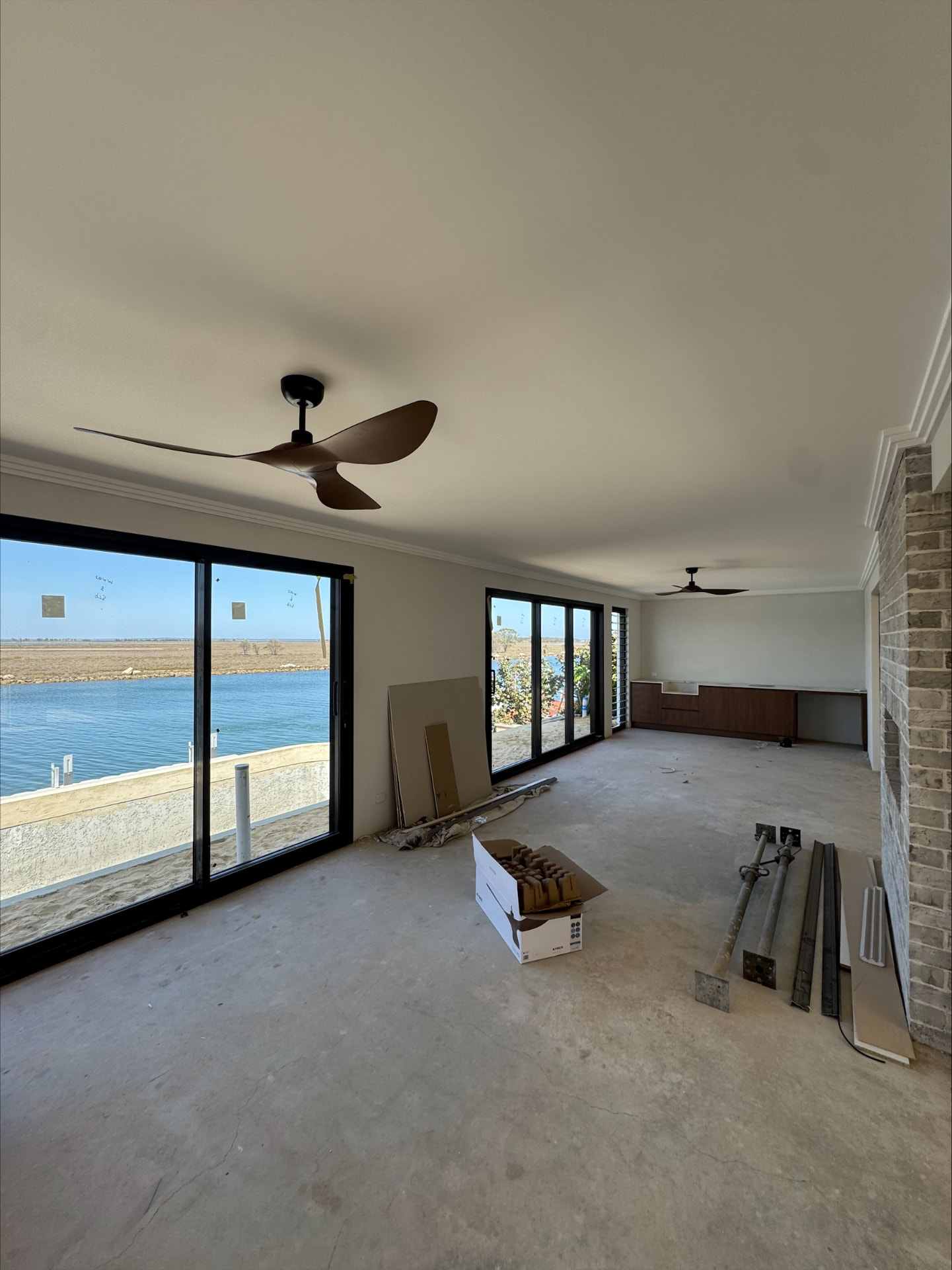 Two modern three-blade ceiling fans installed in a Perth home under construction with waterfront views, fitted by McGuires Electrical Contractors