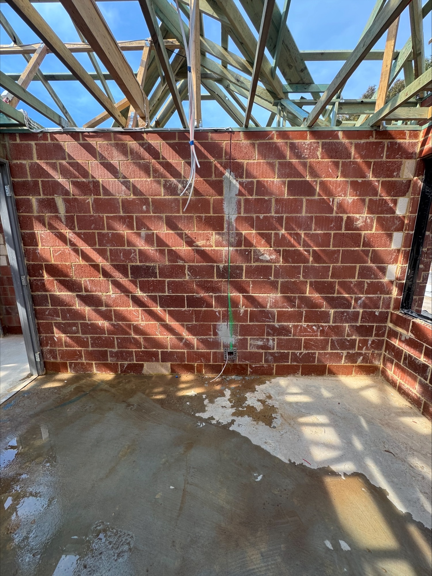 Electrical cabling roughed in down a double-brick wall at a Glen Iris, Jandakot new build