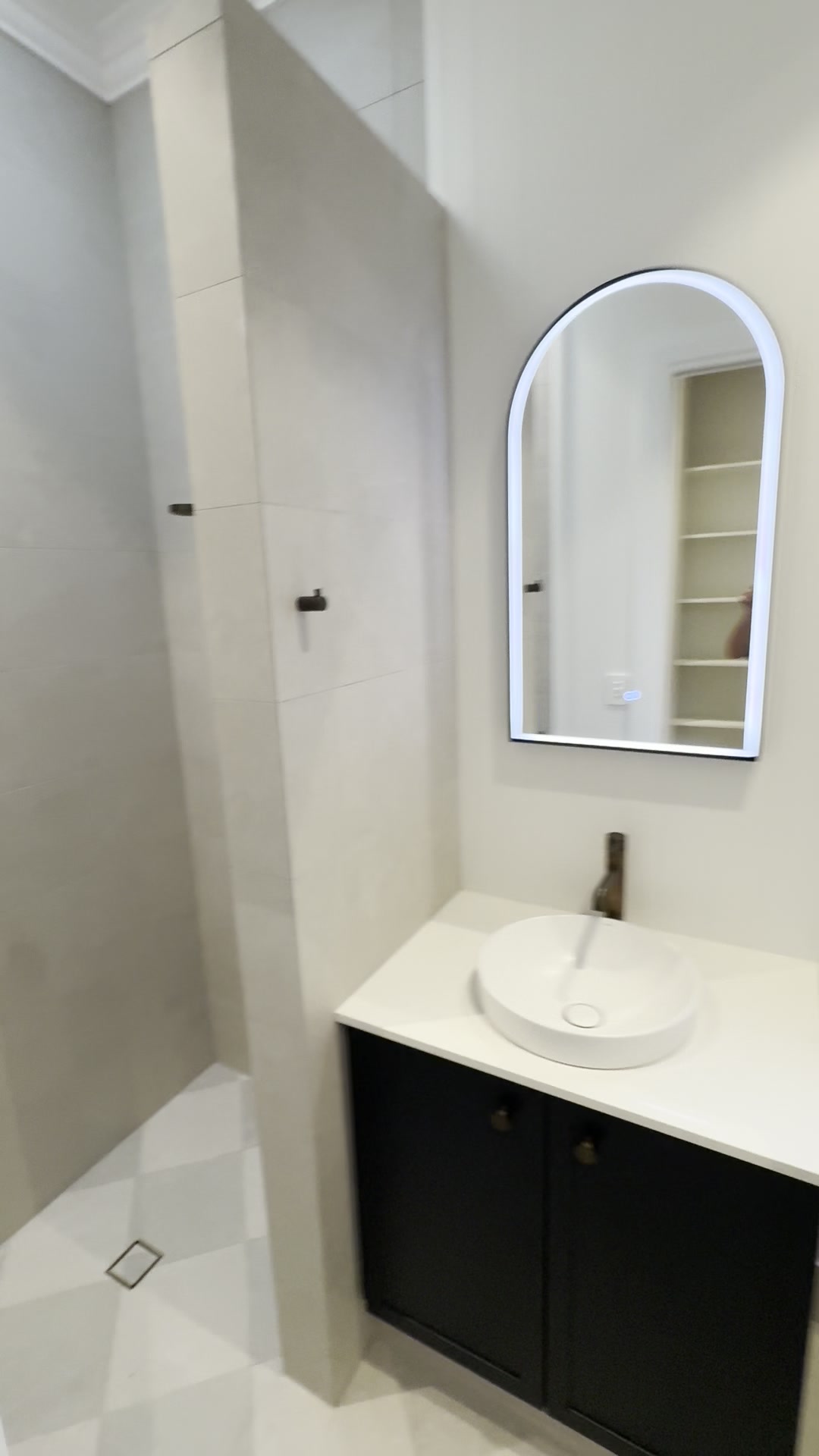 Tiled walk-in shower with grab rail and new lighting in a Nedlands home renovation