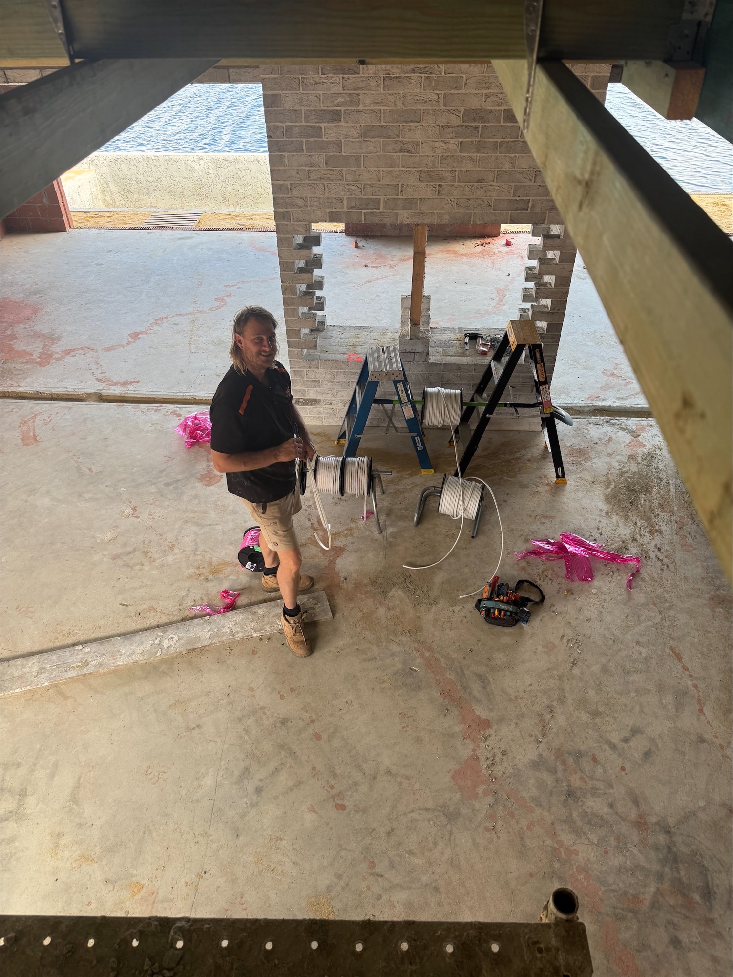 McGuires Electrical electrician running cable on a reel during the rough-in of a coastal Perth home renovation