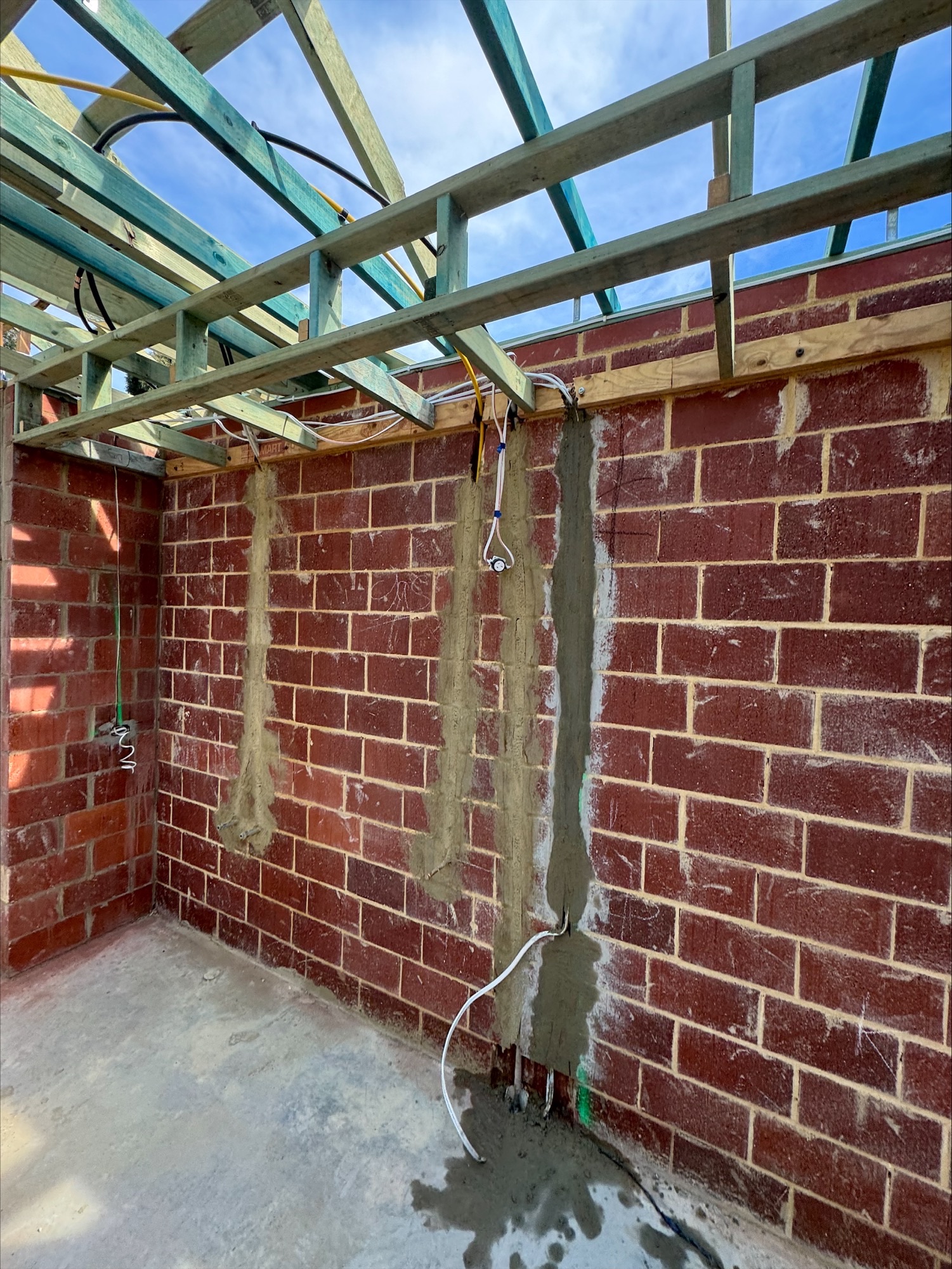 Chased and rendered cable runs in brickwork during a new home electrical rough-in at Glen Iris, Jandakot